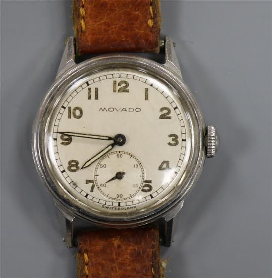 A gentlemans 1940s stainless steel Movado mid size manual wind wrist watch.